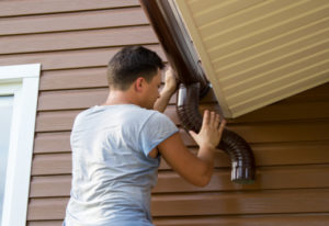 man attaching gutters